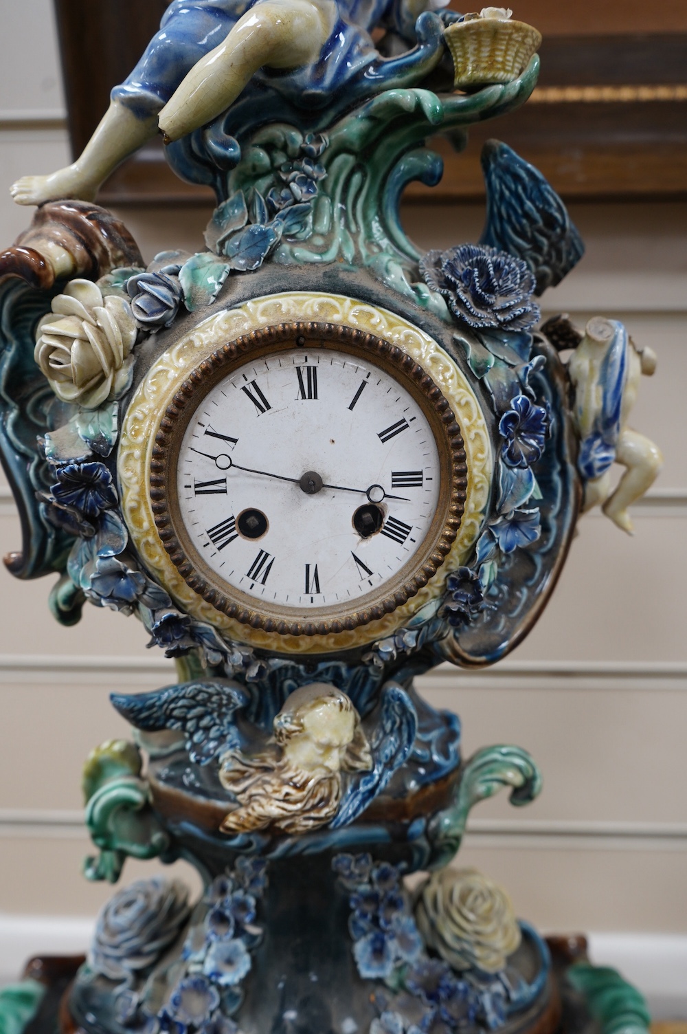 A Rorstrand pottery figural clock garniture with enamel dial and floral encrusted decoration, largest 57cm high. Condition - poor